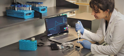 Scientist performing experiment in lab using GX102 potentiostat